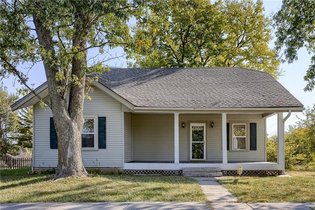 view of front of property with a front yard and covered porch