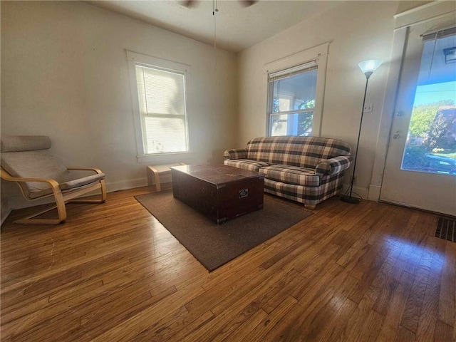 living room with hardwood / wood-style flooring and ceiling fan