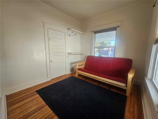 sitting room with wood-type flooring