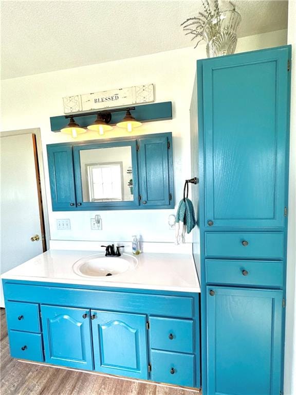 bathroom featuring a textured ceiling, vanity, and hardwood / wood-style floors