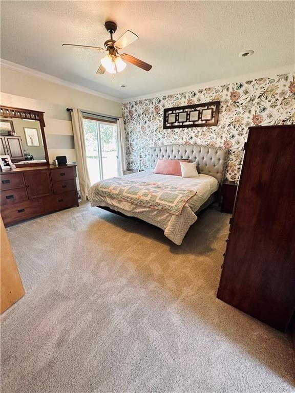 carpeted bedroom featuring ceiling fan, a textured ceiling, and ornamental molding