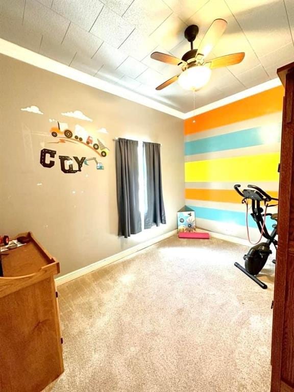 recreation room featuring ceiling fan, ornamental molding, and carpet