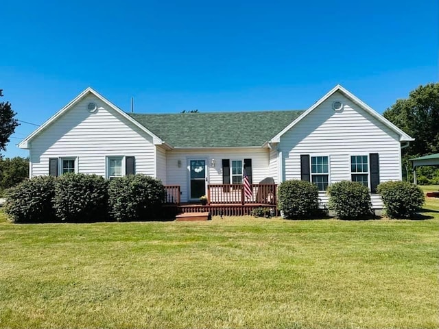 back of house with a deck and a yard