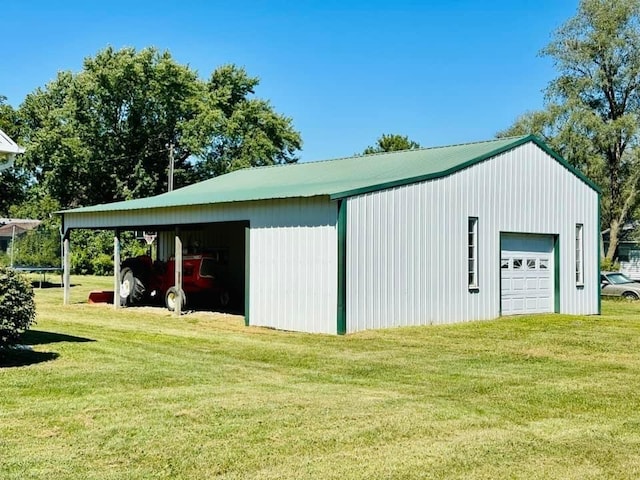 view of outdoor structure with a garage and a yard