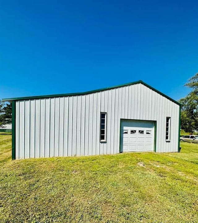 view of outbuilding with a lawn and a garage