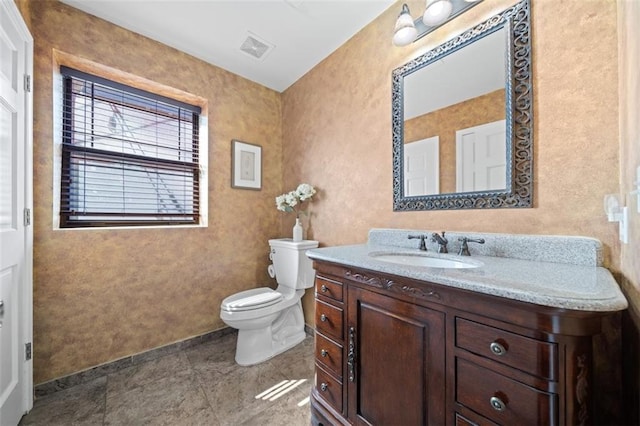 bathroom featuring vanity, tile patterned flooring, and toilet