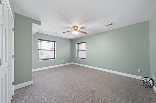 unfurnished room featuring ceiling fan and carpet