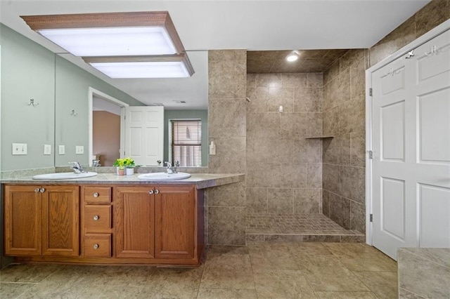 bathroom featuring vanity and tiled shower