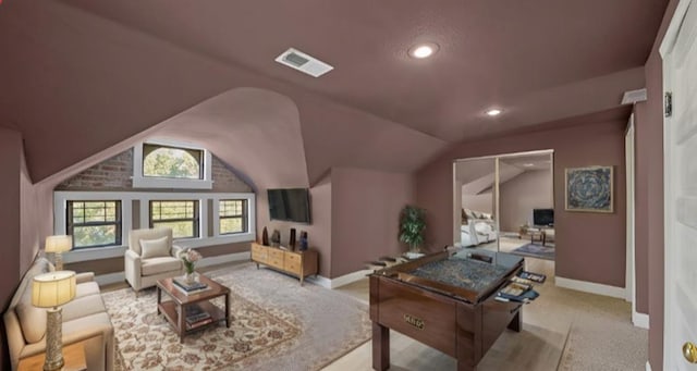 interior space featuring lofted ceiling and light carpet