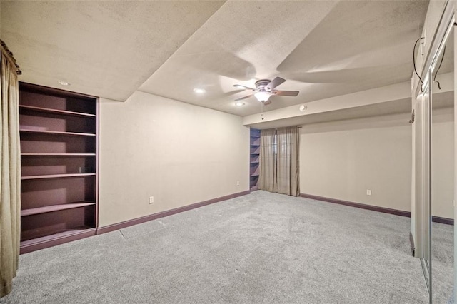 unfurnished bedroom featuring ceiling fan, carpet, and a textured ceiling