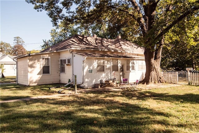 back of property with a lawn