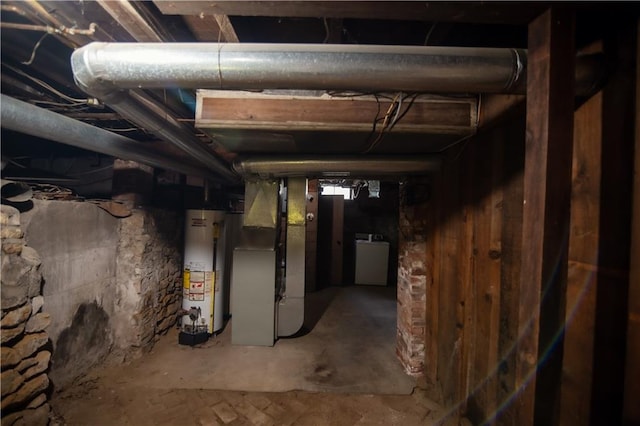 basement featuring water heater and heating unit