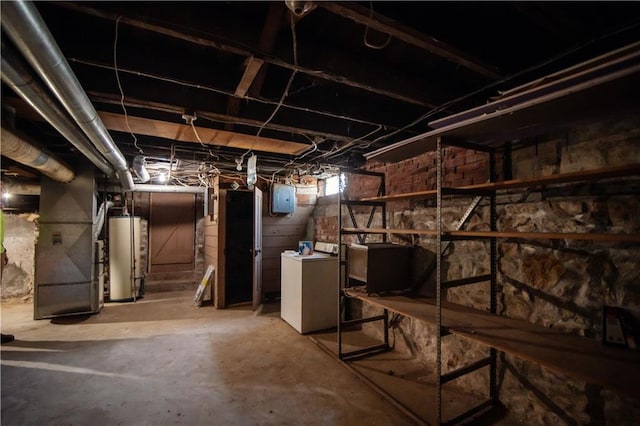 basement featuring gas water heater, electric panel, and washer / dryer