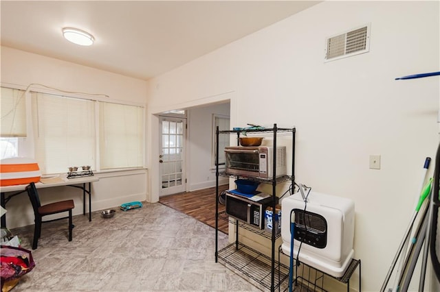 home office featuring heating unit and light hardwood / wood-style floors