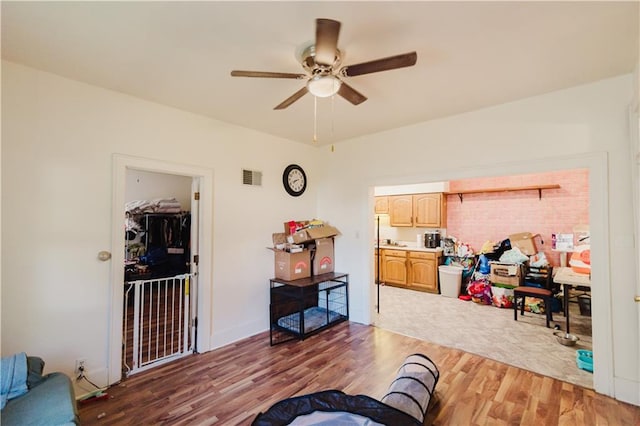 living room featuring ceiling fan and hardwood / wood-style flooring