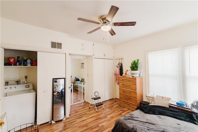 bedroom with light wood-type flooring, washer / clothes dryer, and ceiling fan