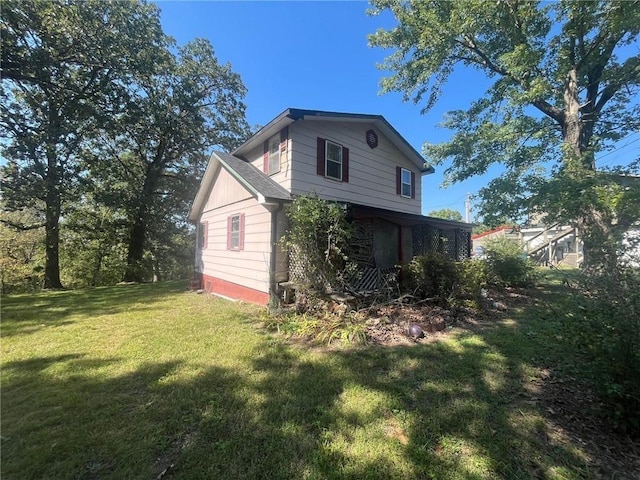 view of side of home with a lawn