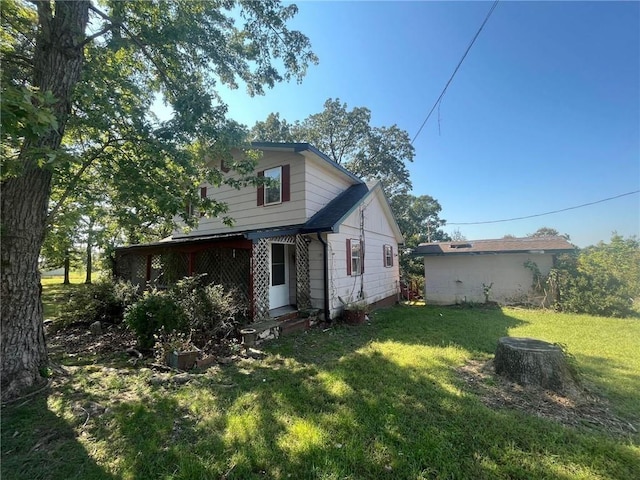 view of side of property with a lawn