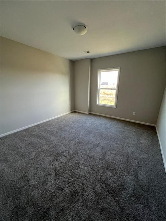 empty room with dark carpet