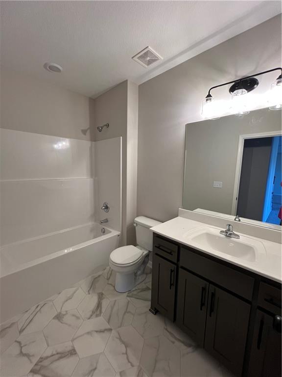 full bathroom featuring vanity, toilet, and shower / washtub combination