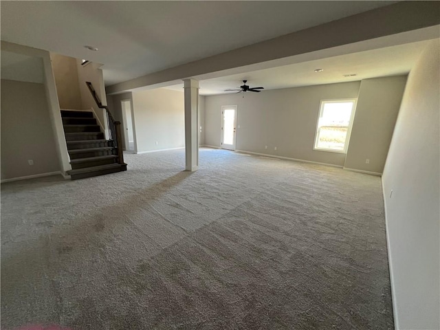 unfurnished living room with ceiling fan, plenty of natural light, and carpet floors