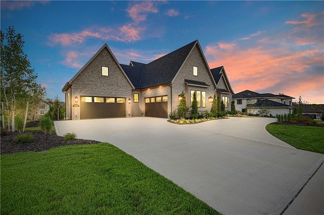 21396 W 93rd Ct, Lenexa, KS 66220 - view of front of house with concrete driveway, a front yard, a garage, brick siding, and stone siding