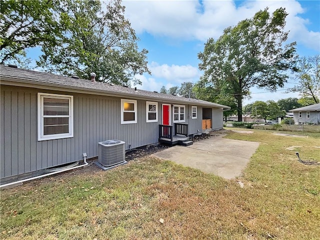 exterior space with a yard, a patio area, and central air condition unit