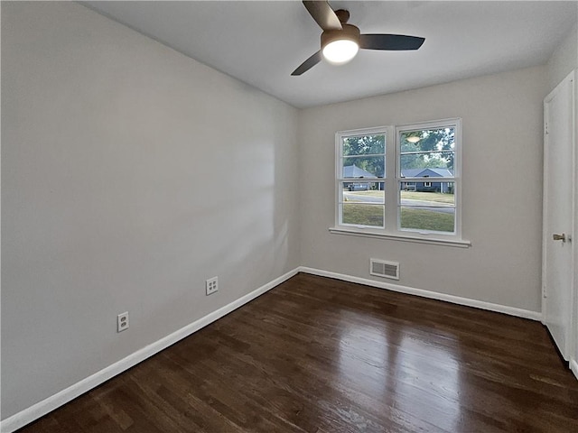 unfurnished room with ceiling fan and dark hardwood / wood-style floors