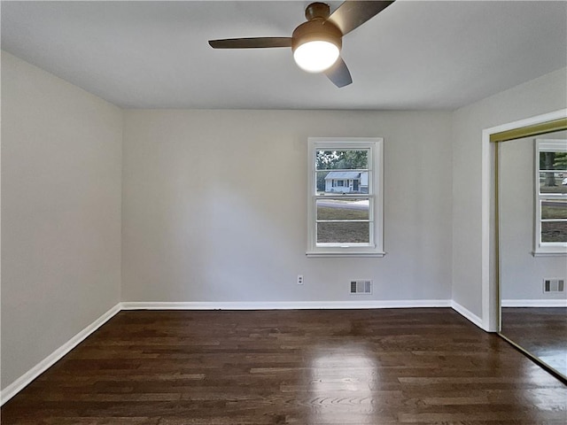 spare room featuring dark hardwood / wood-style floors and ceiling fan