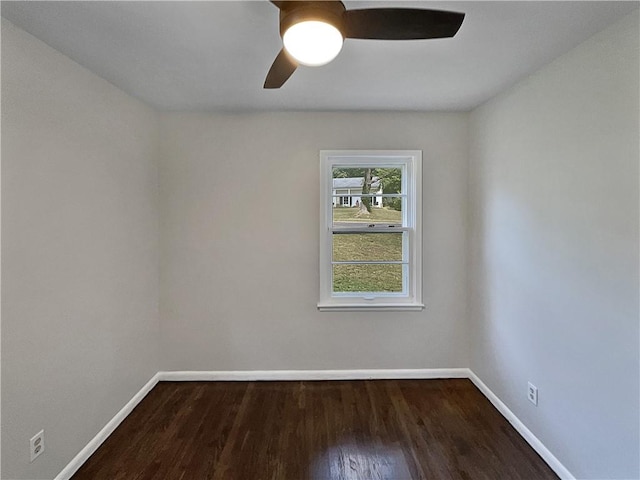 unfurnished room featuring dark wood-type flooring and ceiling fan