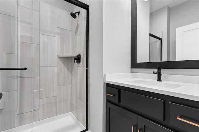 bathroom with a shower stall and vanity