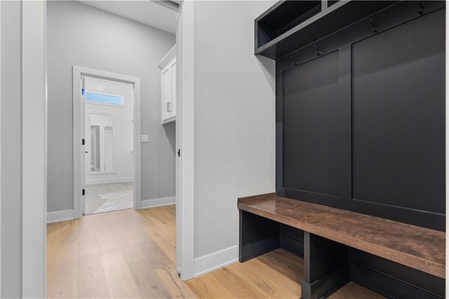 mudroom featuring light wood-style flooring and baseboards