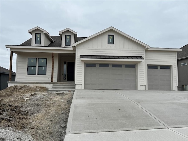 view of front of house with an attached garage, driveway, and board and batten siding