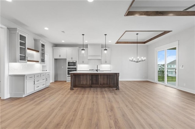 1617 SW Arbor Park Dr, Lees Summit, MO 64082 - kitchen featuring appliances with stainless steel finishes, decorative backsplash, light wood-type flooring, white cabinetry, and light countertops