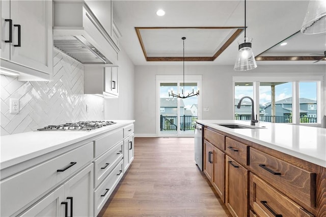 1617 SW Arbor Park Dr, Lees Summit, MO 64082 - kitchen with a raised ceiling, appliances with stainless steel finishes, plenty of natural light, premium range hood, and recessed lighting