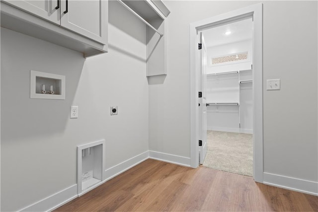 1617 SW Arbor Park Dr, Lees Summit, MO 64082 - laundry area with cabinet space, washer hookup, electric dryer hookup, and wood finished floors