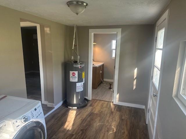 interior space with water heater, plenty of natural light, and washer / clothes dryer