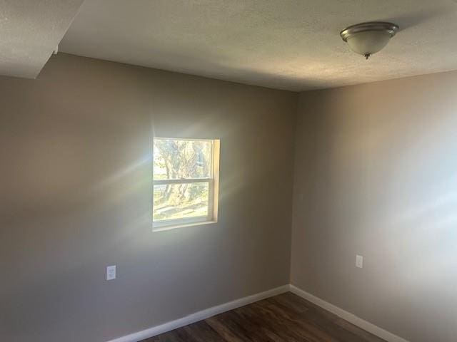 spare room with dark hardwood / wood-style floors