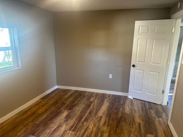 spare room with dark hardwood / wood-style flooring