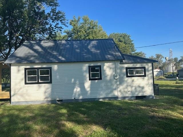 view of side of home with a yard