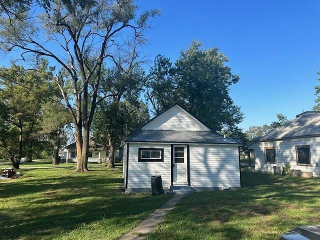 view of outbuilding with a yard