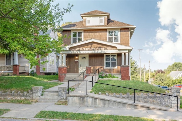 view of front of house with a porch and a front yard