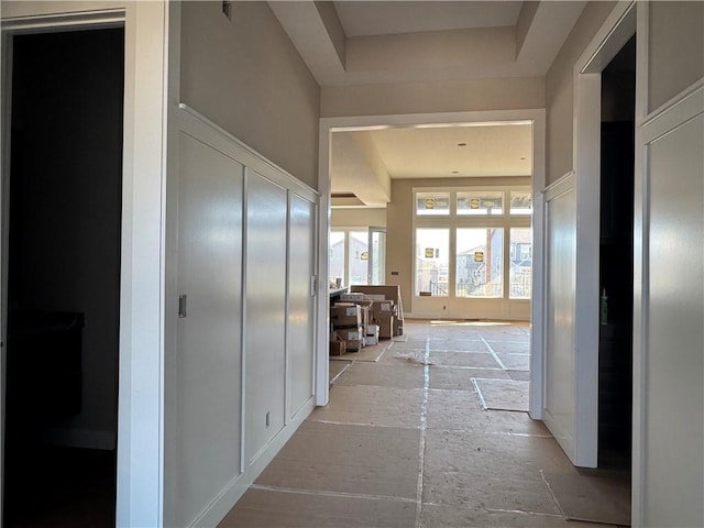 hallway featuring a raised ceiling