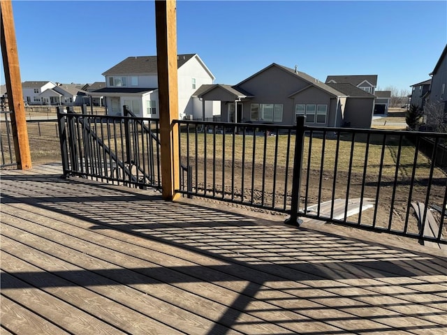 view of gate featuring a residential view and a yard