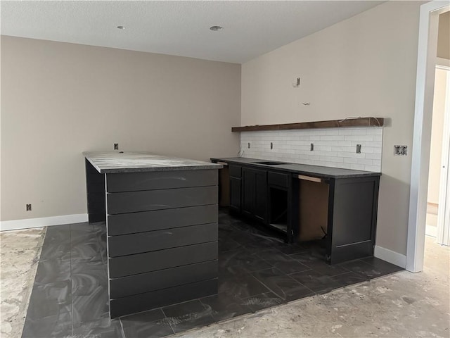 interior space featuring a sink and baseboards