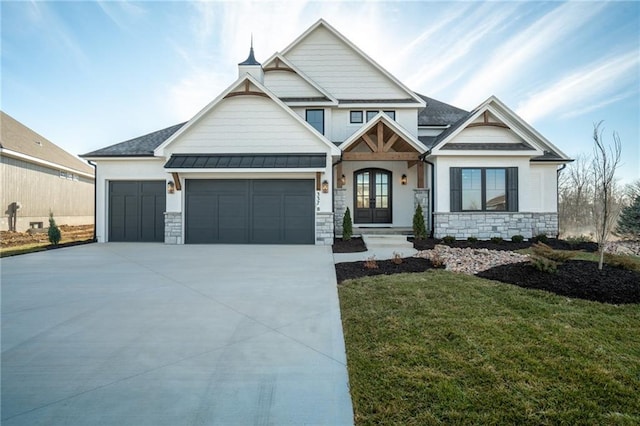 craftsman house with a garage and a front lawn