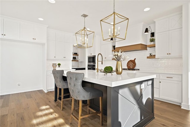 kitchen with white cabinets and light wood-type flooring