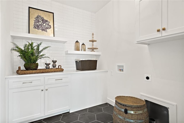 laundry area with cabinets, dark tile patterned flooring, electric dryer hookup, and hookup for a washing machine