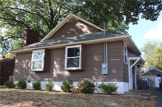 view of side of home with central AC unit