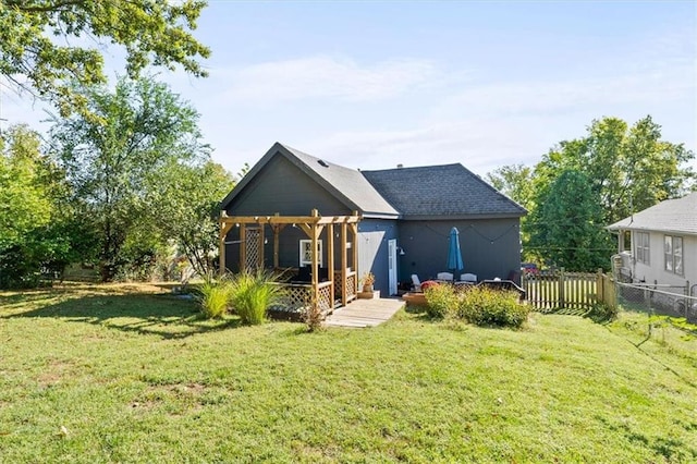 back of house with a lawn